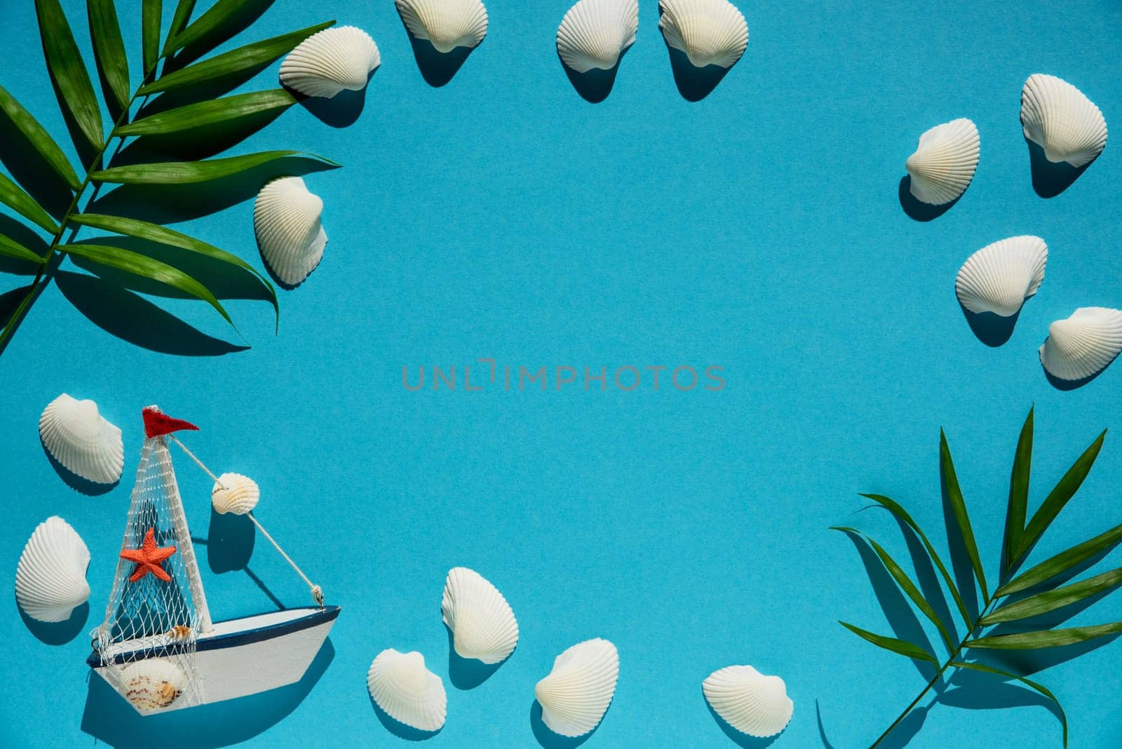 Flat Lay With Copy Space For Your Free Text. Turquoise Or Blue Background With Maritime Decoration Like Boat, Shells And Palm Leaf.