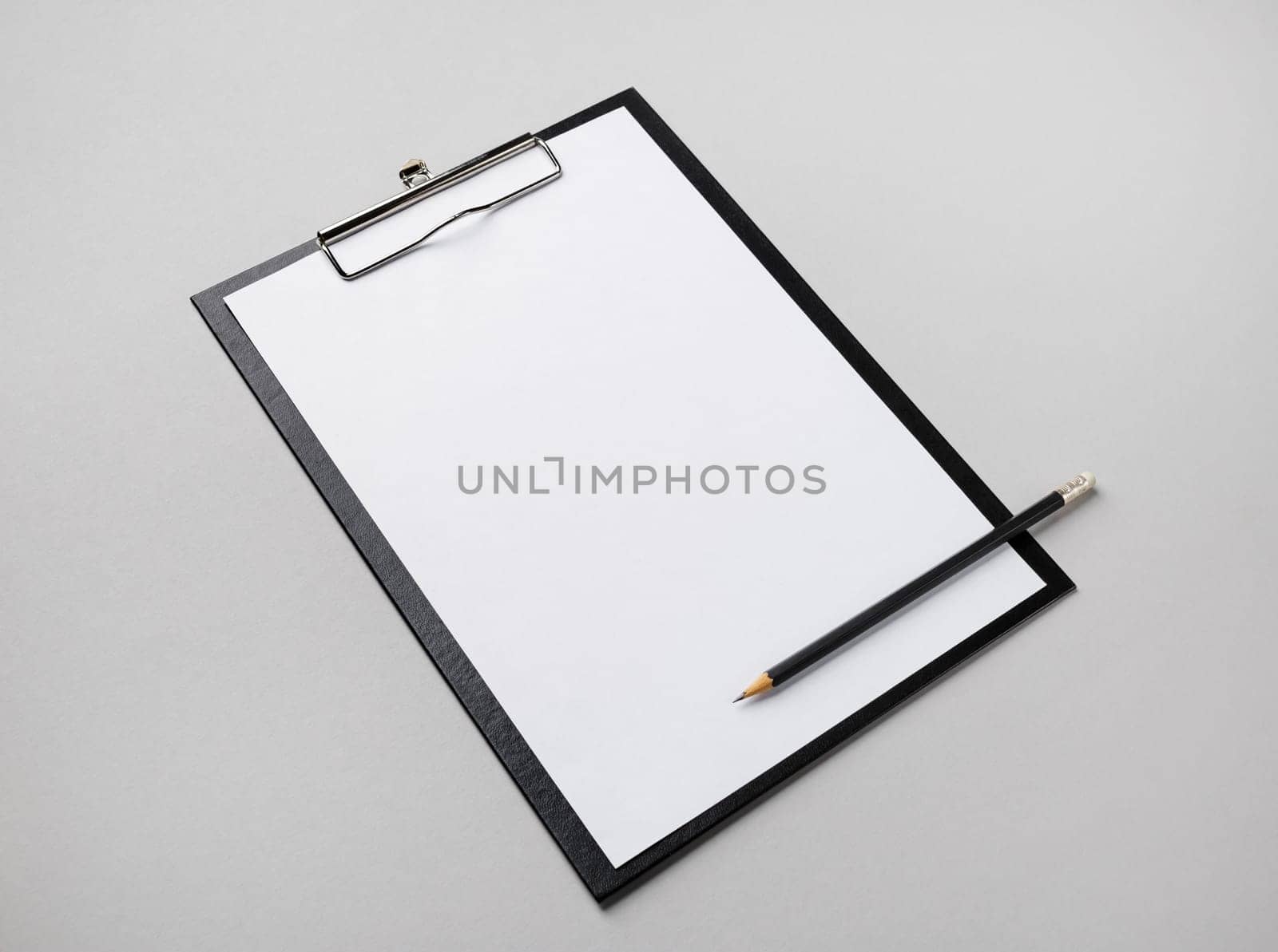 Blank letterhead, clipboard and pencil on gray paper background. Responsive design template.
