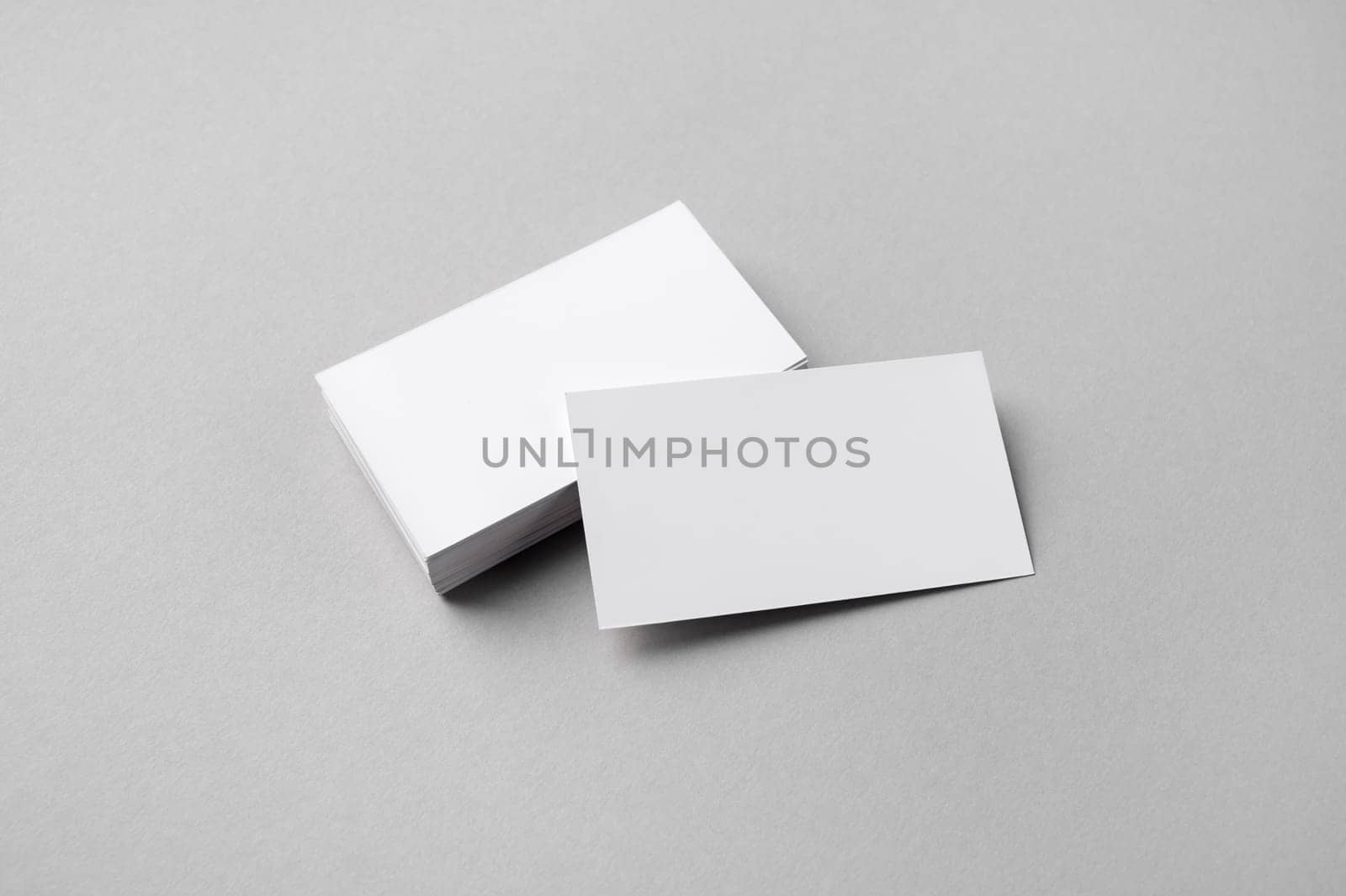 Blank business cards mockup on gray paper background. Copy space for text.