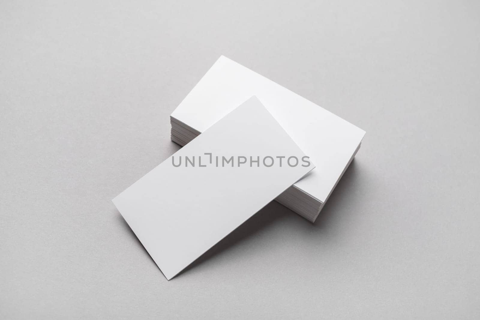 Blank business cards on gray paper background. Mockup for branding identity.