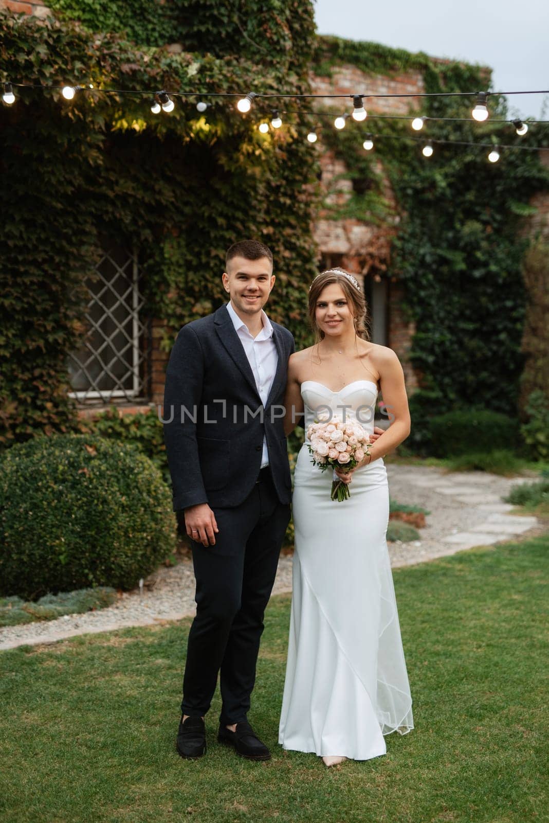portrait of a young couple of bride and groom on their wedding day in a country cottage