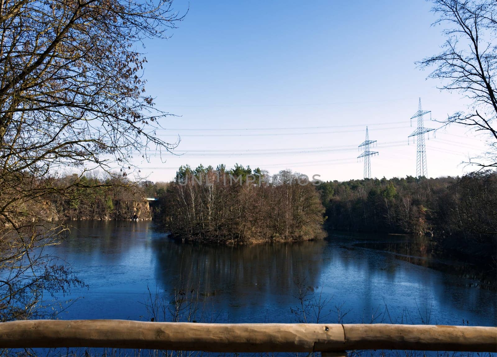 little green isle in a stone pits lake, local recreation area, power poles in the back
