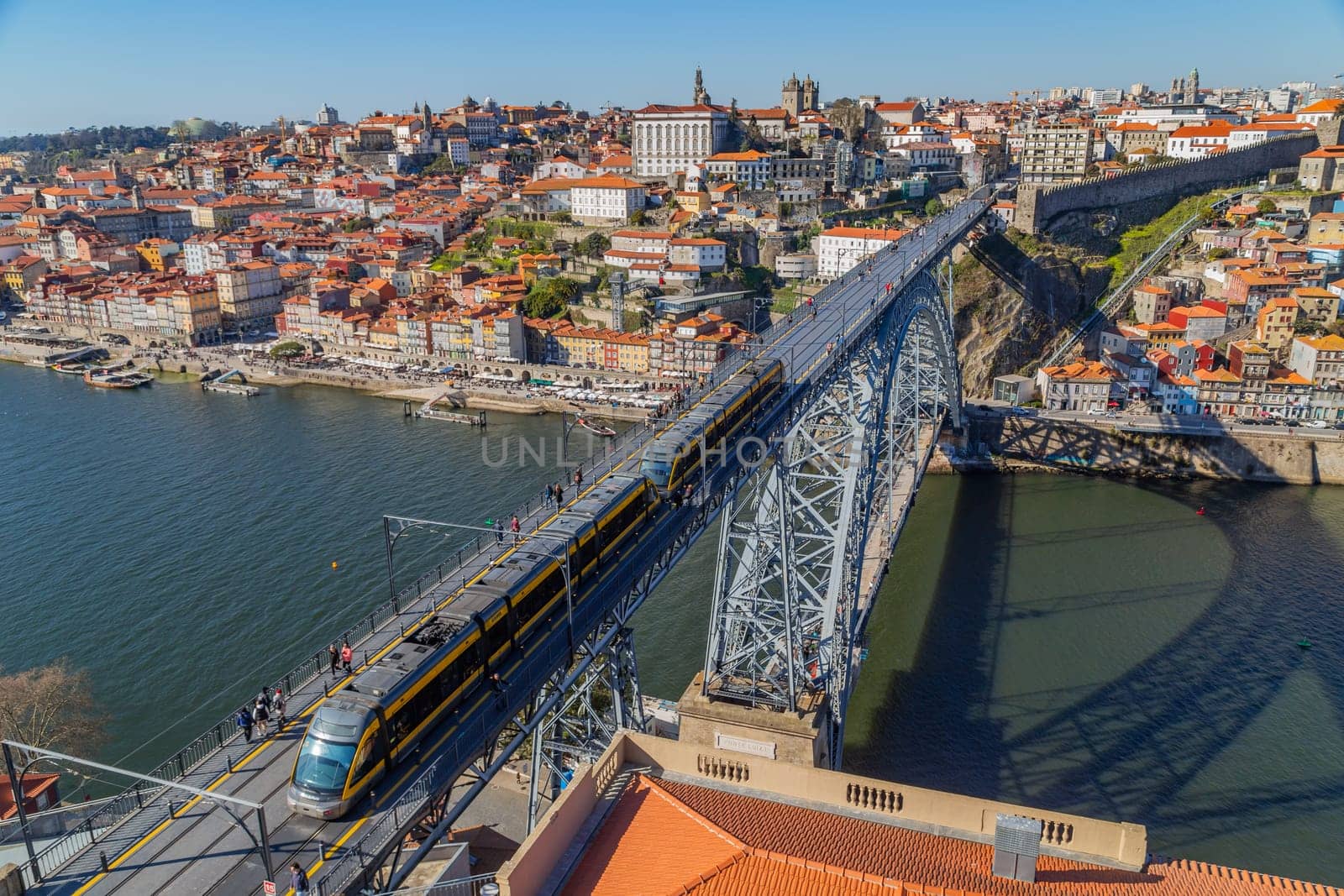 Porto, Portugal - March 02, 2023: View of Ribeira historical quarter on the margin Douro river embankment in the old town and Luis I bridge, Porto, Portugal.