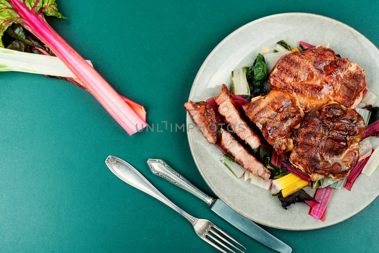 Appetizing roast meat steak with a vegetable garnish. Copy space.