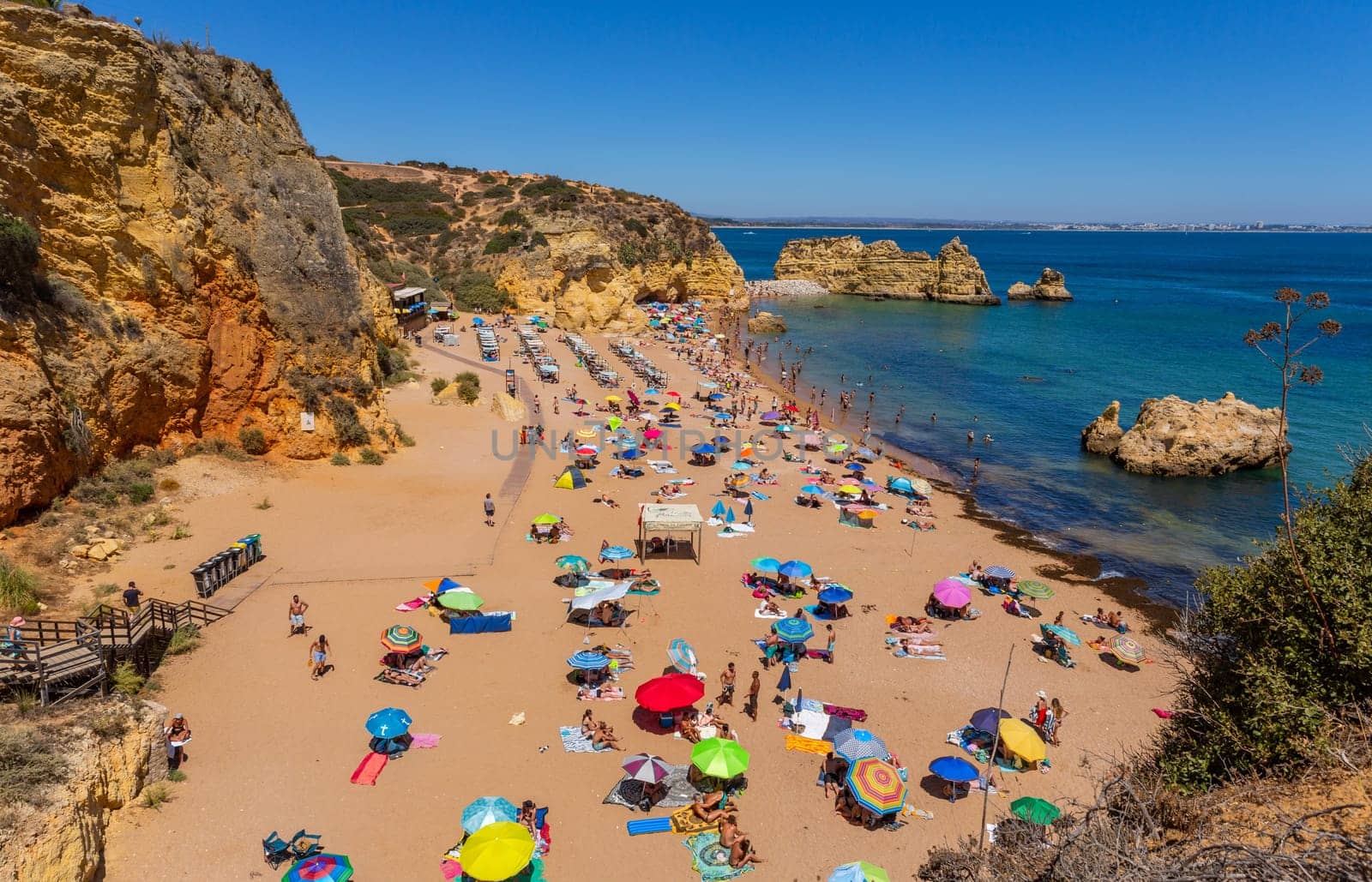 Lagos, Portugal - 25 August 2022: People at Dona Ana beach at Algarve coast in Portugal