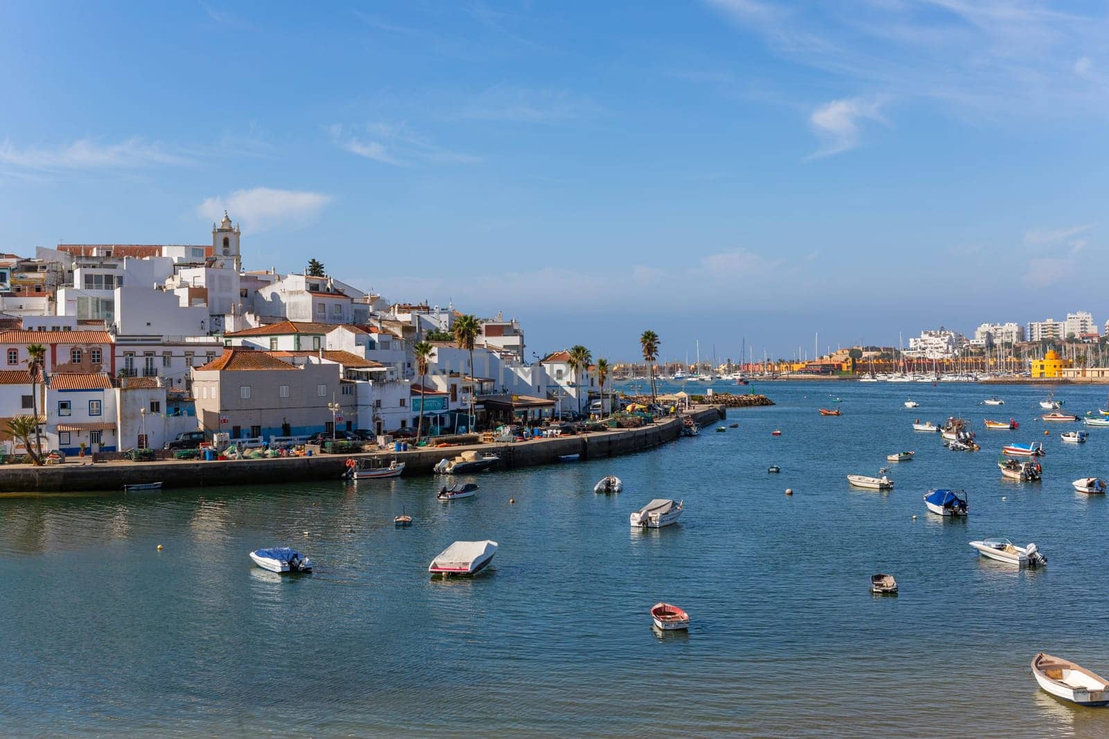 Ferragudo, Portugal - August 25, 2022 - View of the white town with boats moored in the foreground, Ferragudo, Algarve, Portugal, Europe