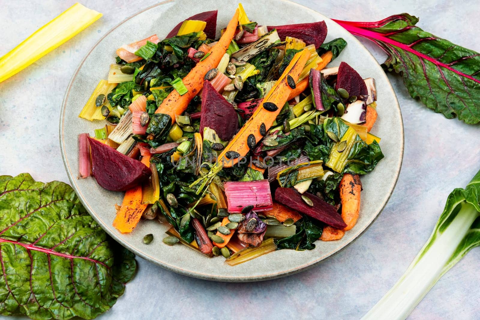 Healthy diet food- stewed chard leaves, beets and carrots. Organic food. Flat lay