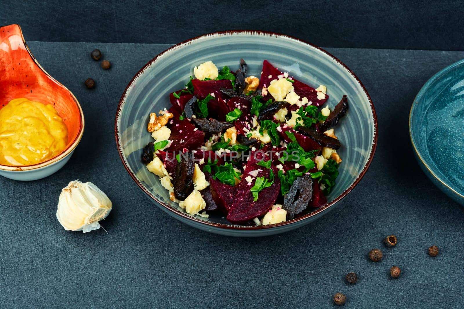 Diet salad of beets, nuts and cheese in bowl.