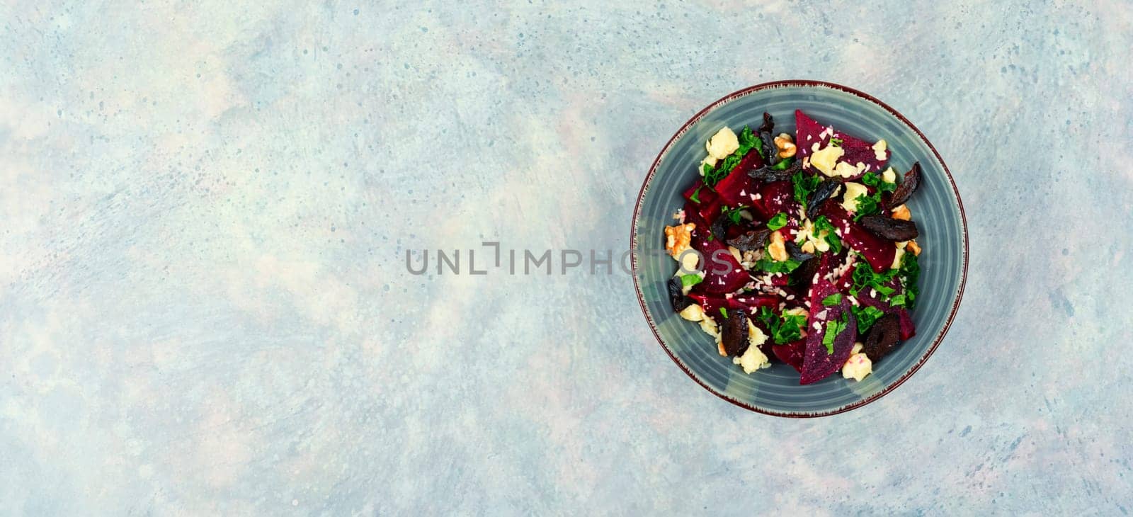 Dietary salad of beetroot, cheese, prunes and nuts. Copy space, recipe place.