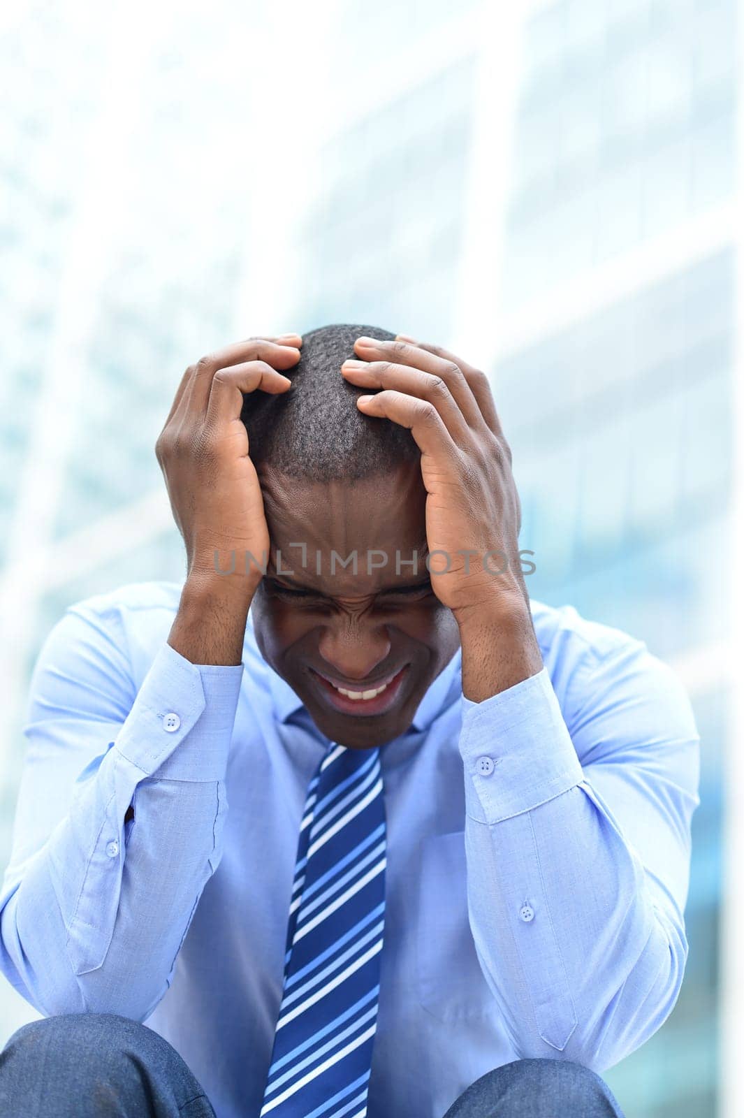 Frustrated businessman sitting in office steps