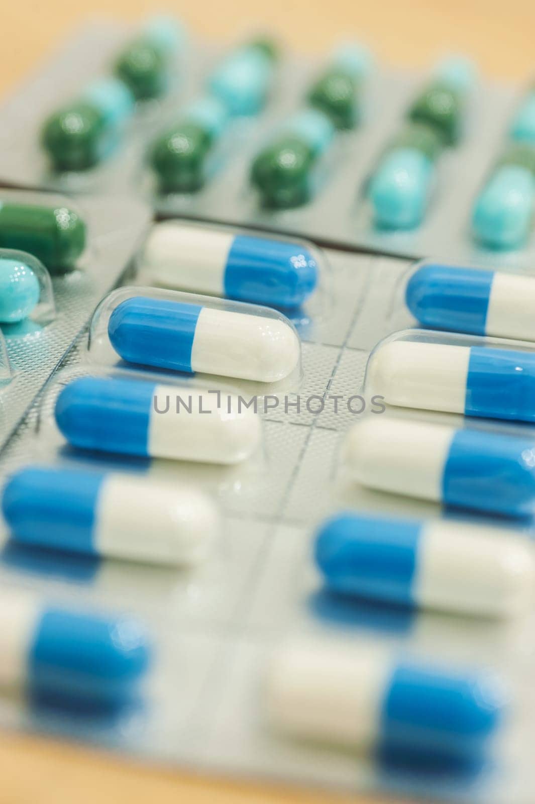 Medicine in capsule on wood table, Selective focus