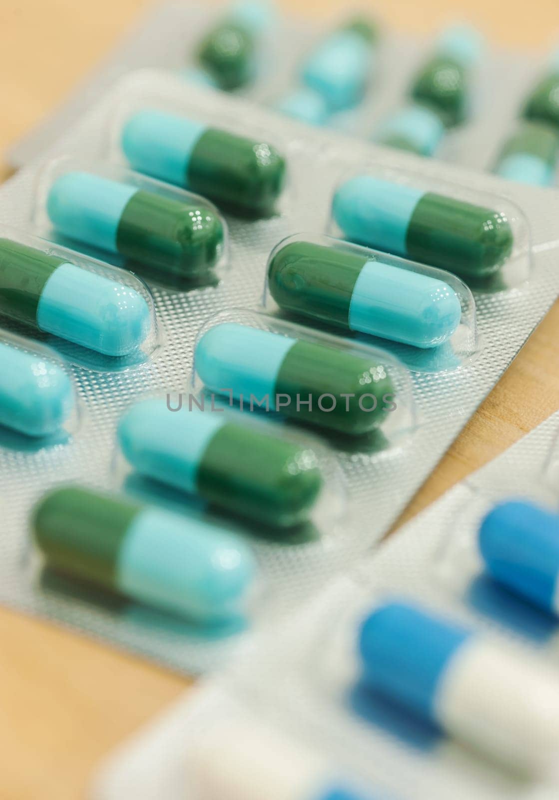 Medicine in capsule on wood table, Selective focus