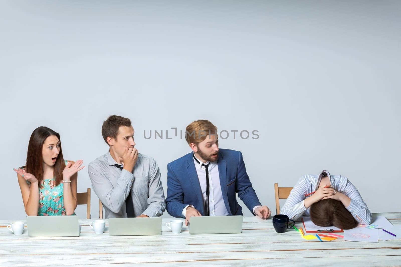 Business team working on their business project together at office on light gray background.  Everyone is wondering, boss sleeping. copyspace image.