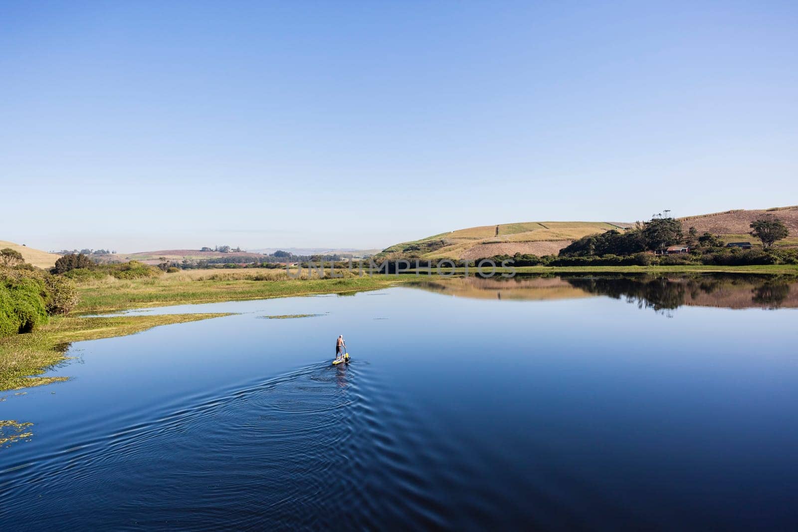 Blue lagoon rural river water paddler board  coastline scenic landscape