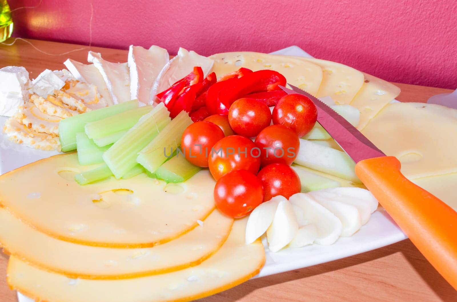 Cheese platter garnished with fruit and vegetables/cheese platter.