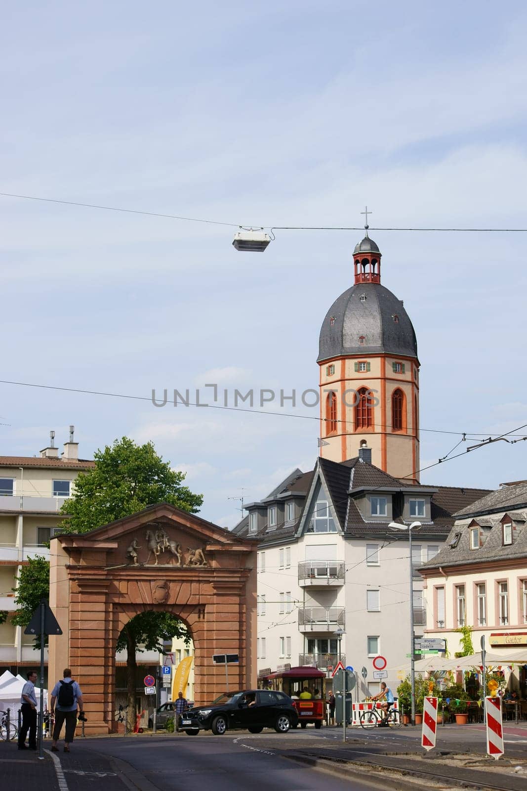 Mainz,Germany – July 10,2015: A photographer and another person stand in front of the Gautor in the old town of Mainz with the St. Stephan Church in the background on July 10,2015 in Mainz.