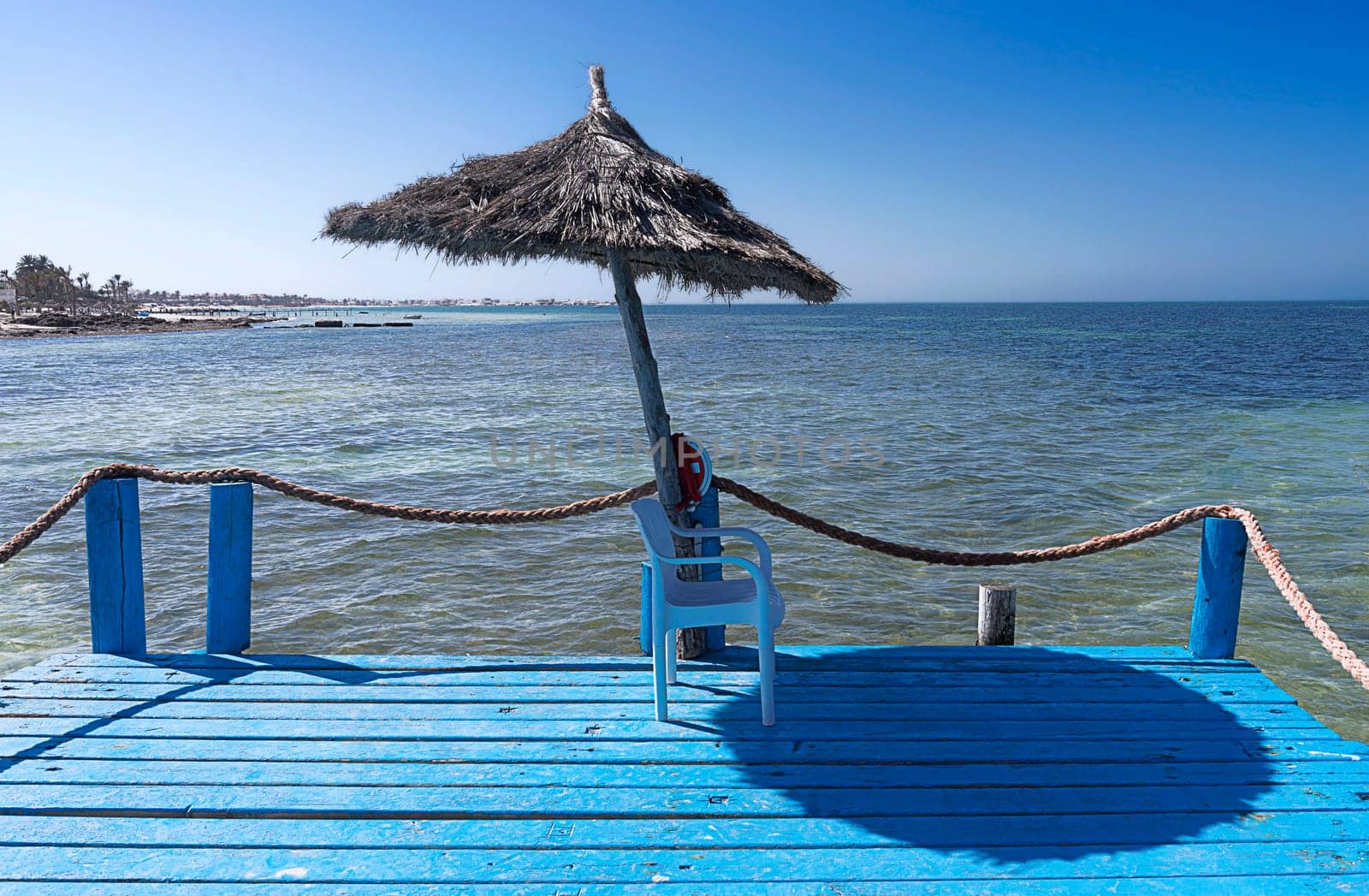 the parasol by the blue sea