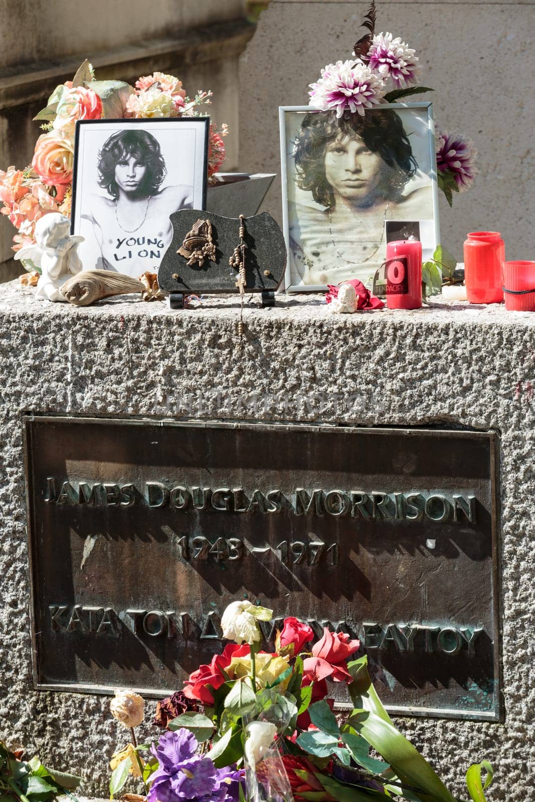 PARIS, FRANCE - SEPT 12, 2014:Jim Morrison grave in Pere-Lachaise cemetery, Paris. Each year thousands fans and curious visitors come to pay homage to Jim Morrison's grave