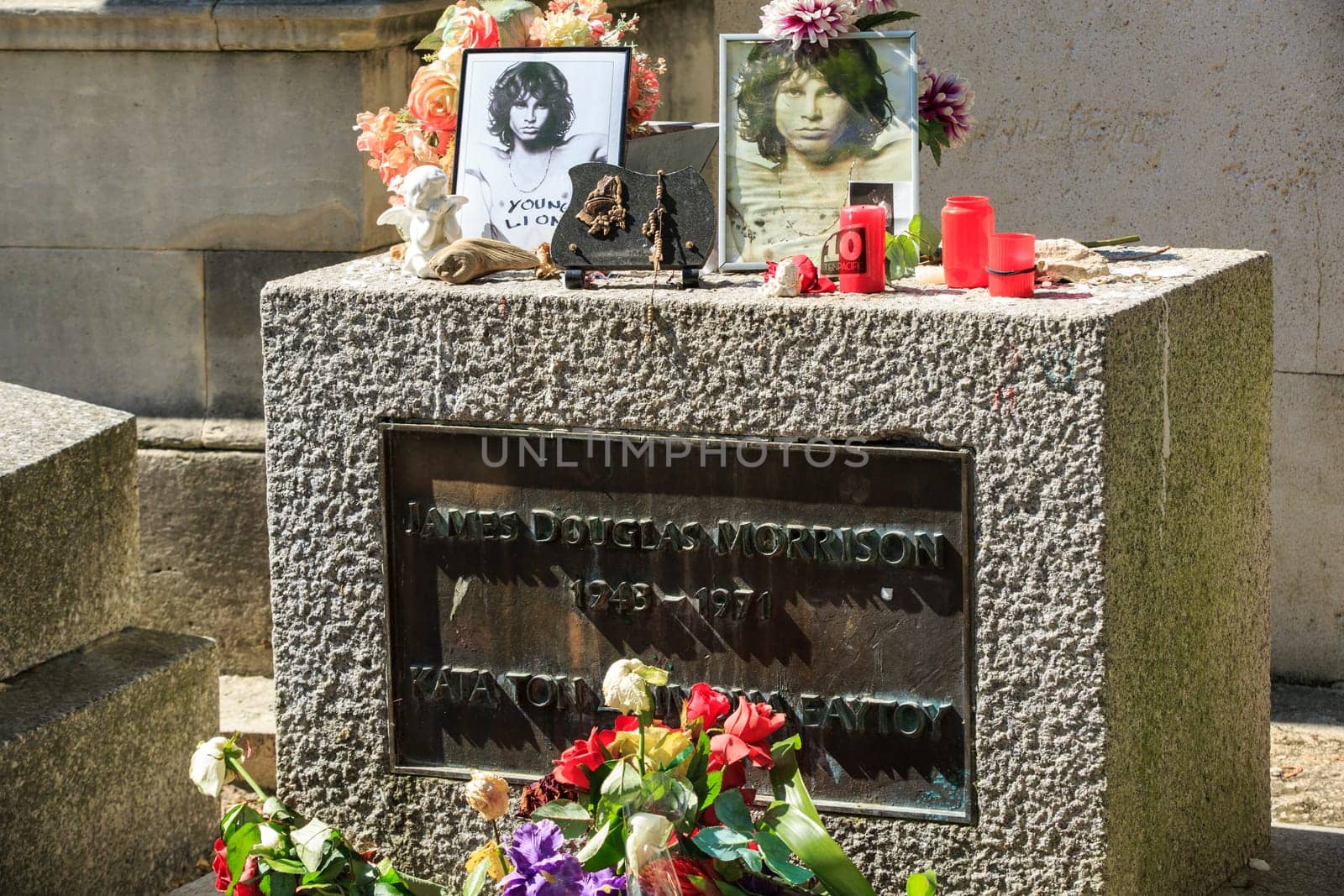 PARIS, FRANCE - SEPT 12, 2014:Jim Morrison grave in Pere-Lachaise cemetery, Paris. Each year thousands fans and curious visitors come to pay homage to Jim Morrison's grave
