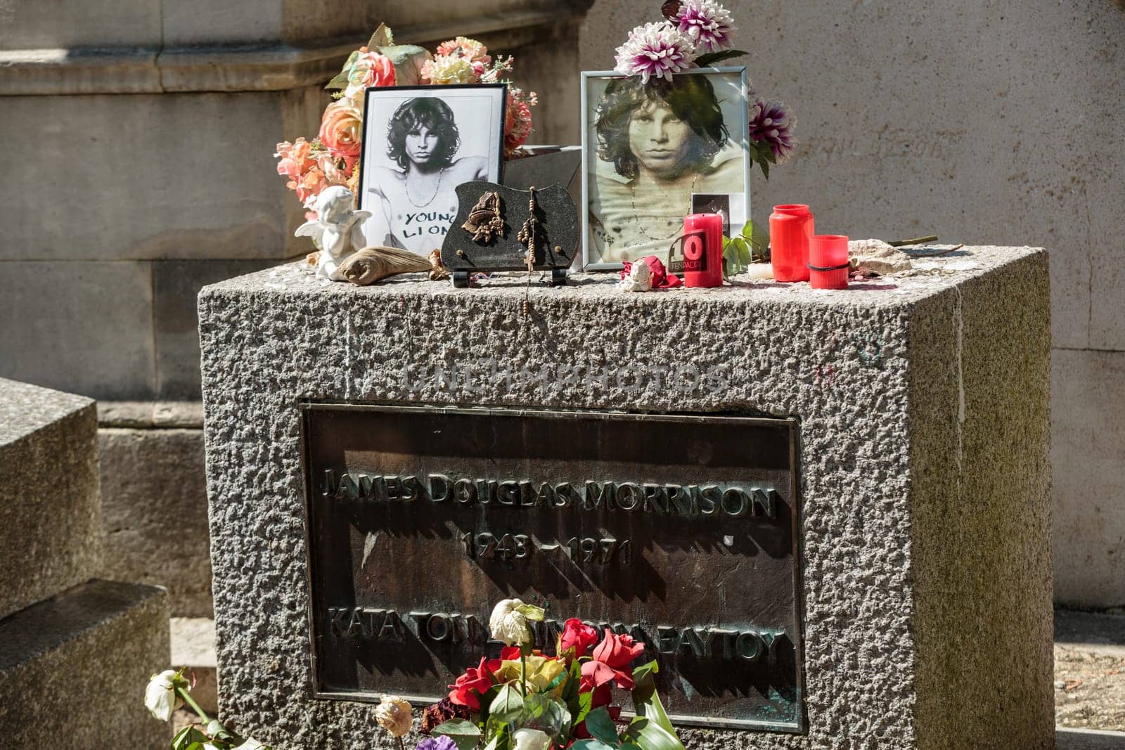 PARIS, FRANCE - SEPT 12, 2014:Jim Morrison grave in Pere-Lachaise cemetery, Paris. Each year thousands fans and curious visitors come to pay homage to Jim Morrison's grave