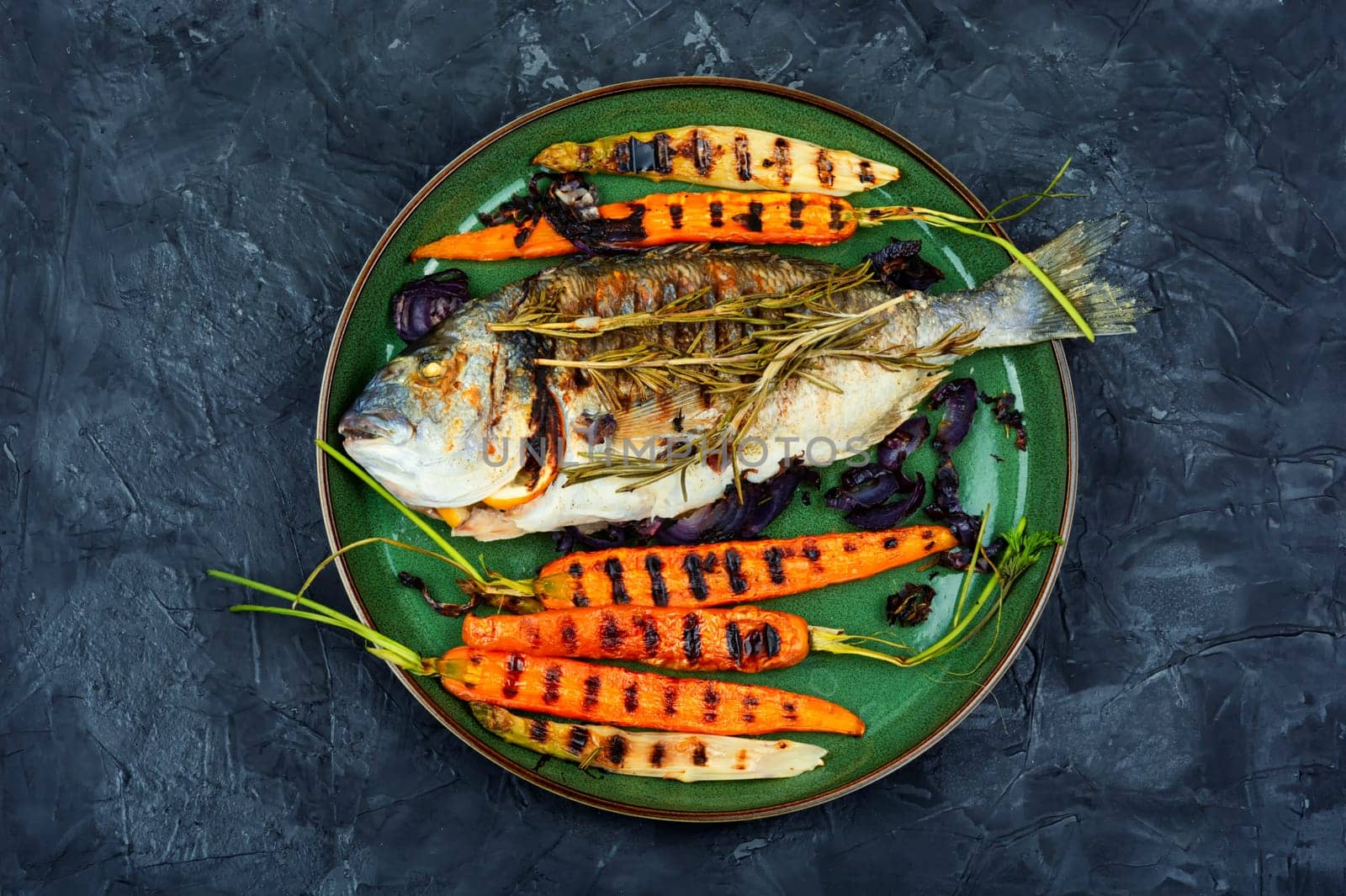Barbecue whole dorado fish or sea bream with grilled vegetables.