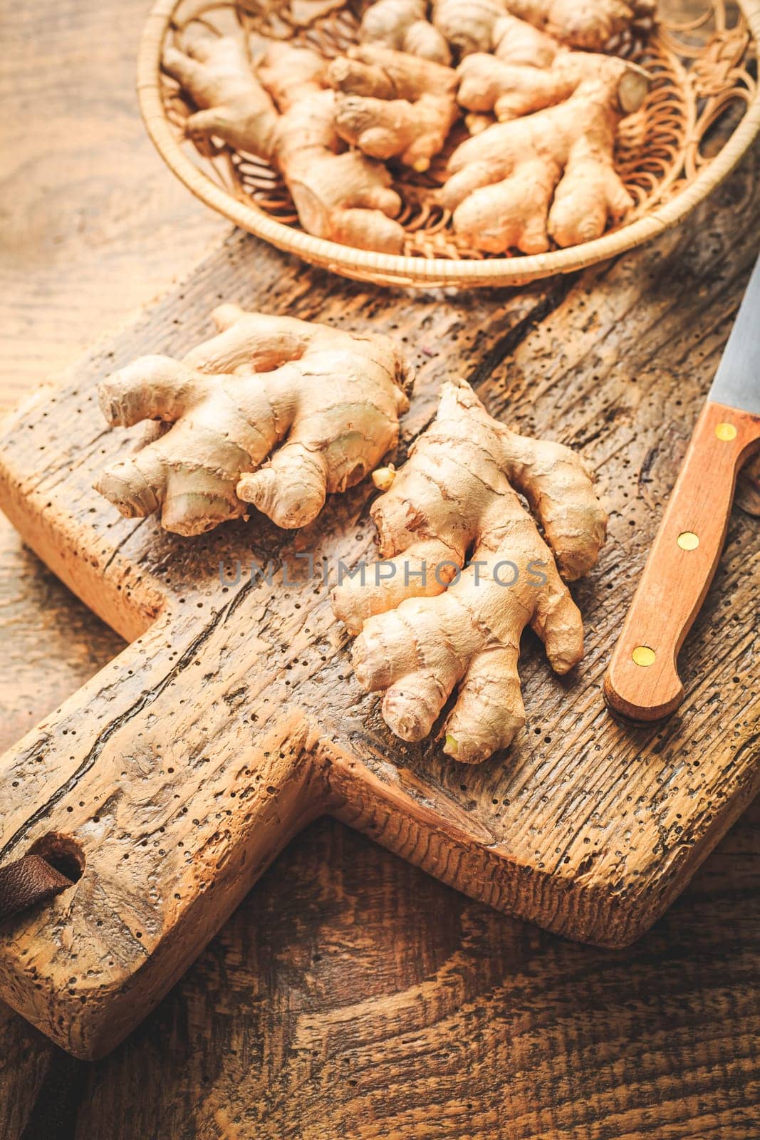 Fresh organic ginger roots on wooden background.