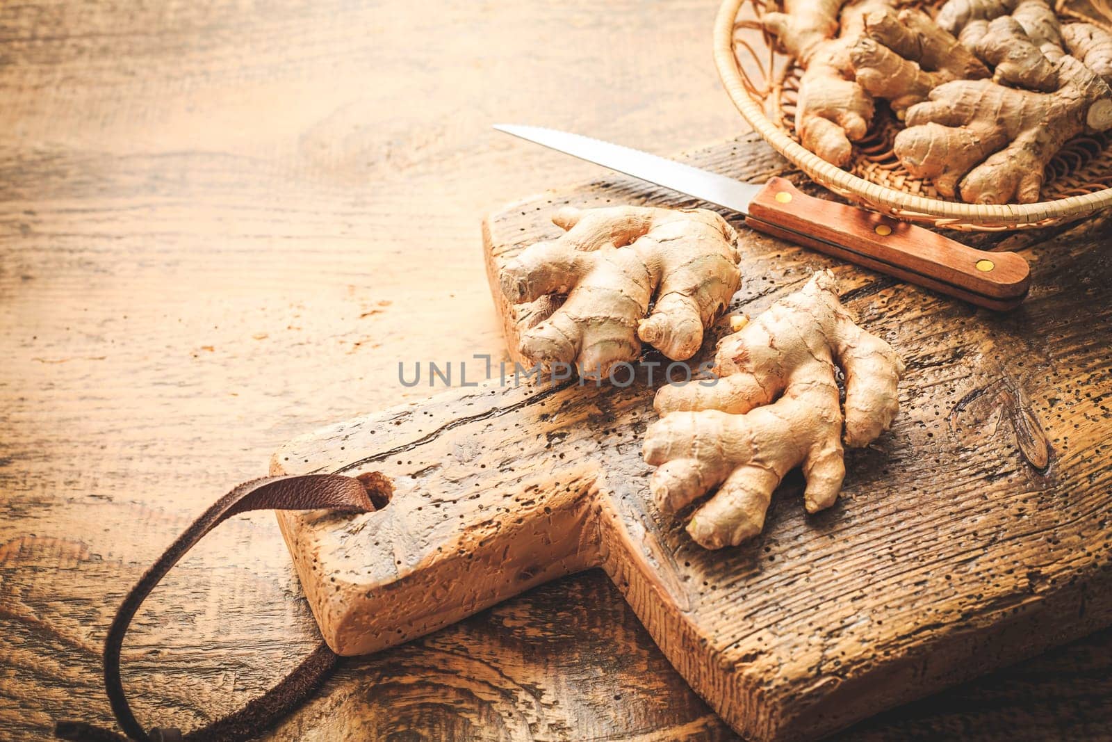 Fresh organic ginger roots on wooden background.
