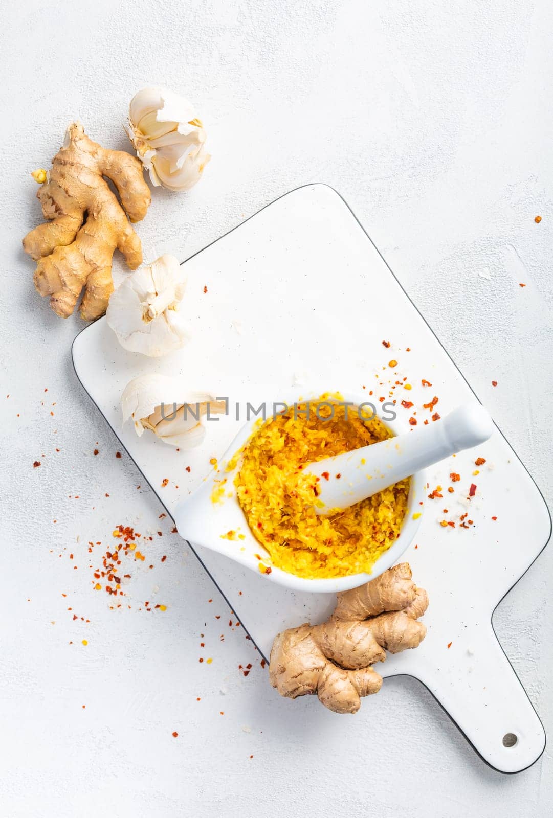 Homemade Fresh Ginger and Garlic paste or Adrak Lahsun puree in ceramic bowl on white background. Asian cuisine