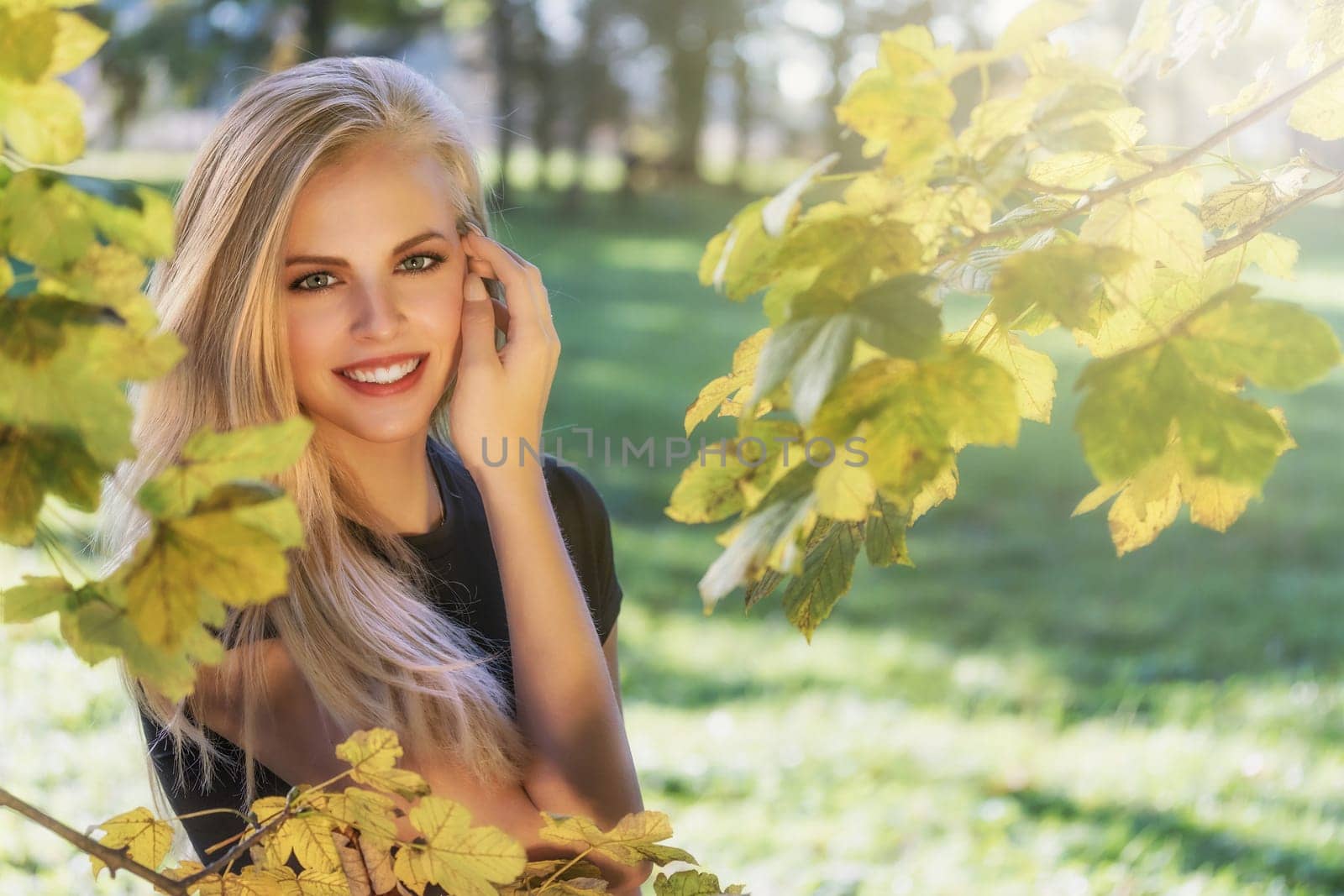 Portrait of smiling attractive long haired young girl posing outdoors.