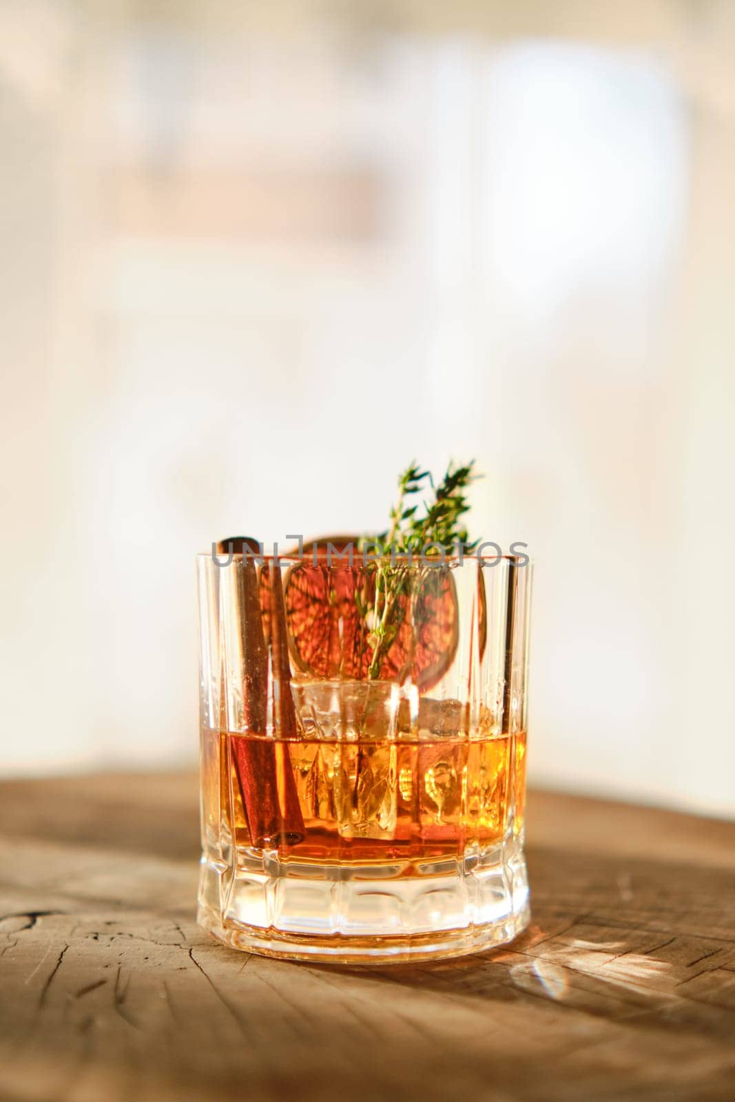 Spicy and sour bourbon and ice sunny cocktail (selective focus photo)