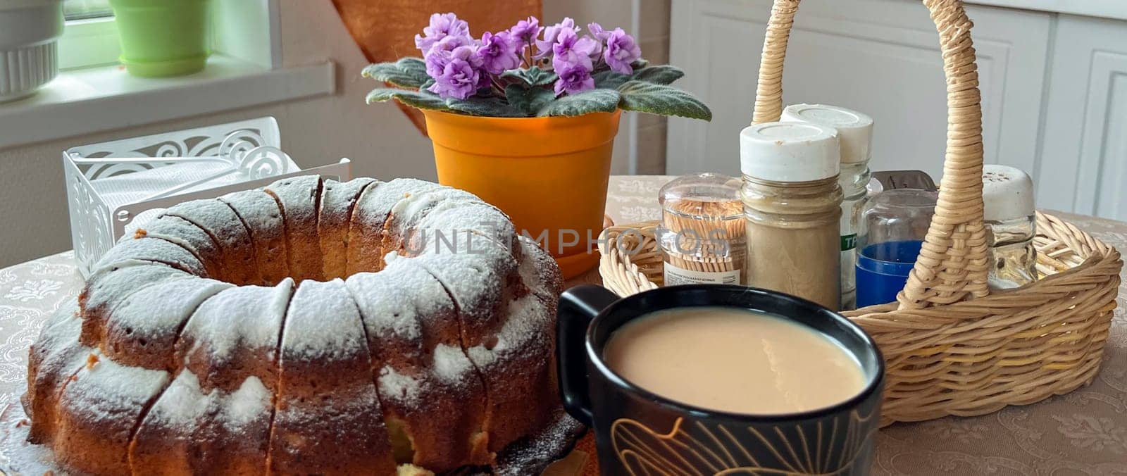 homemade cakes and a cup of coffee with milk on the table