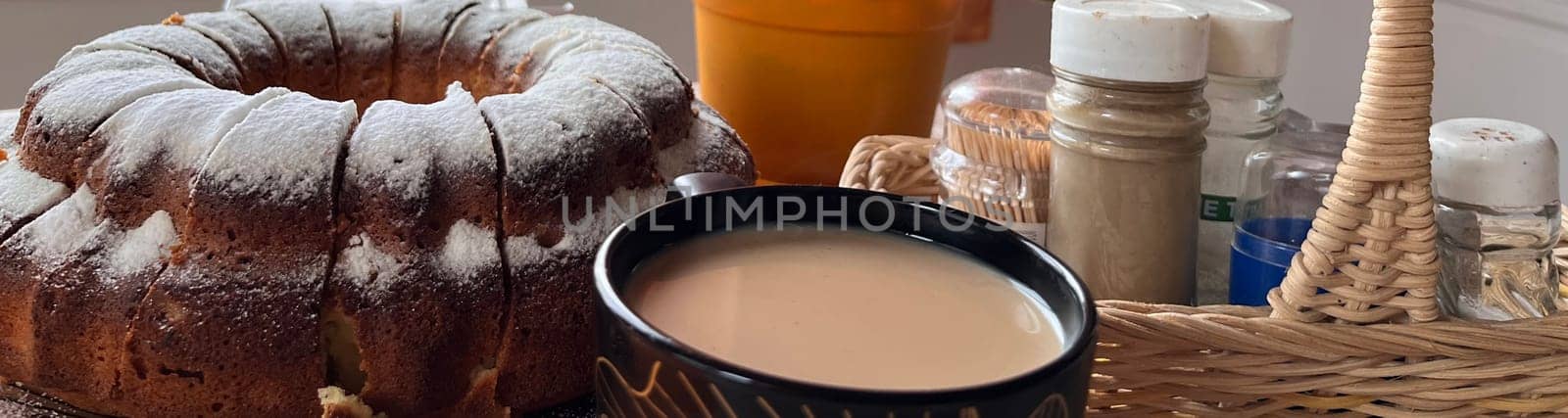 homemade cakes and a cup of coffee with milk on the table
