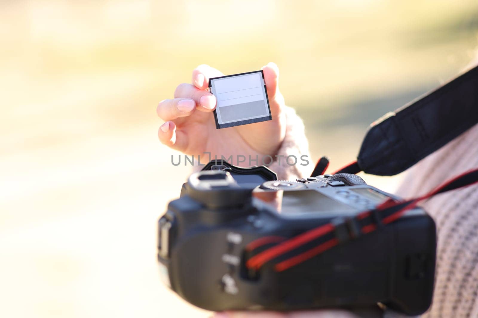 Close up of a photographer changing card on dslr camera