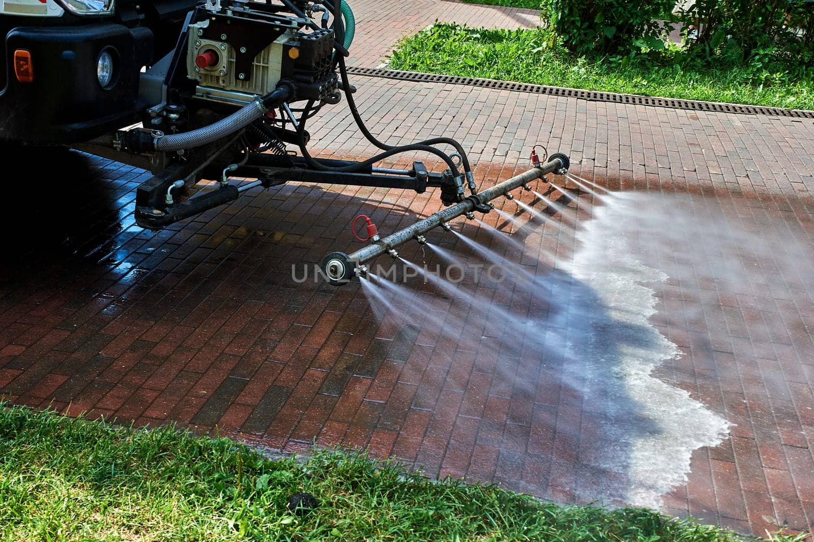 A special machine washes city paths and roads with water. High quality photo