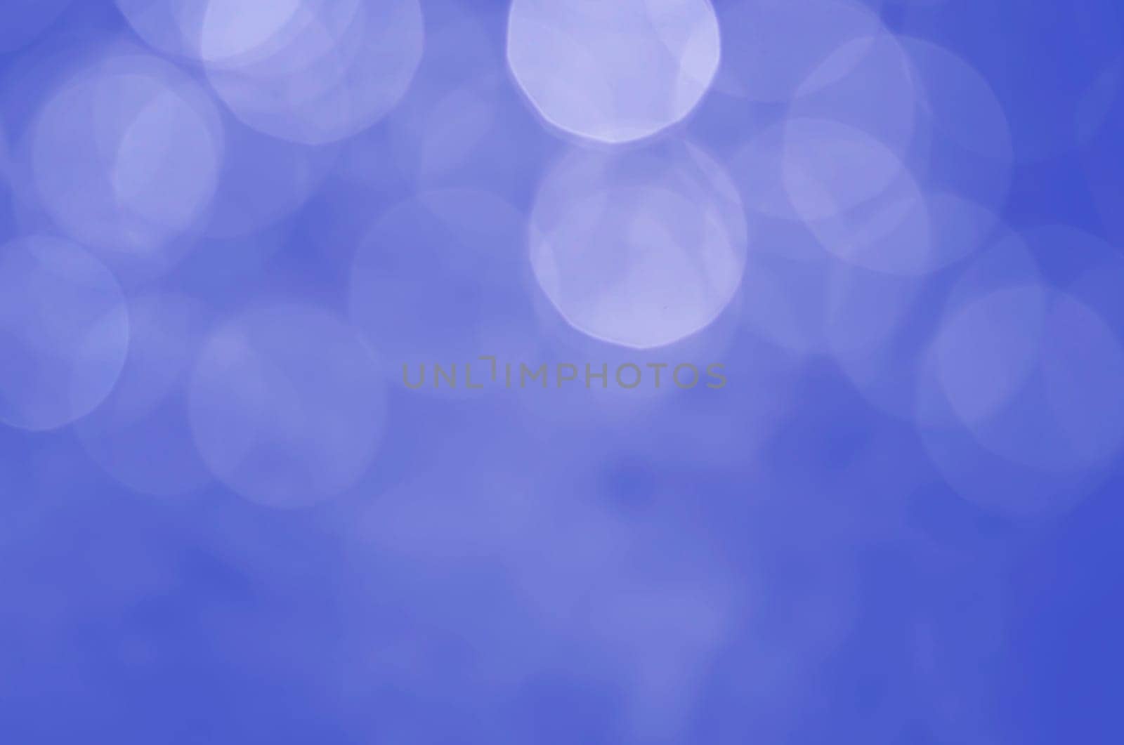 Light abstract blue bokeh christmas circle color glitter blurred black background