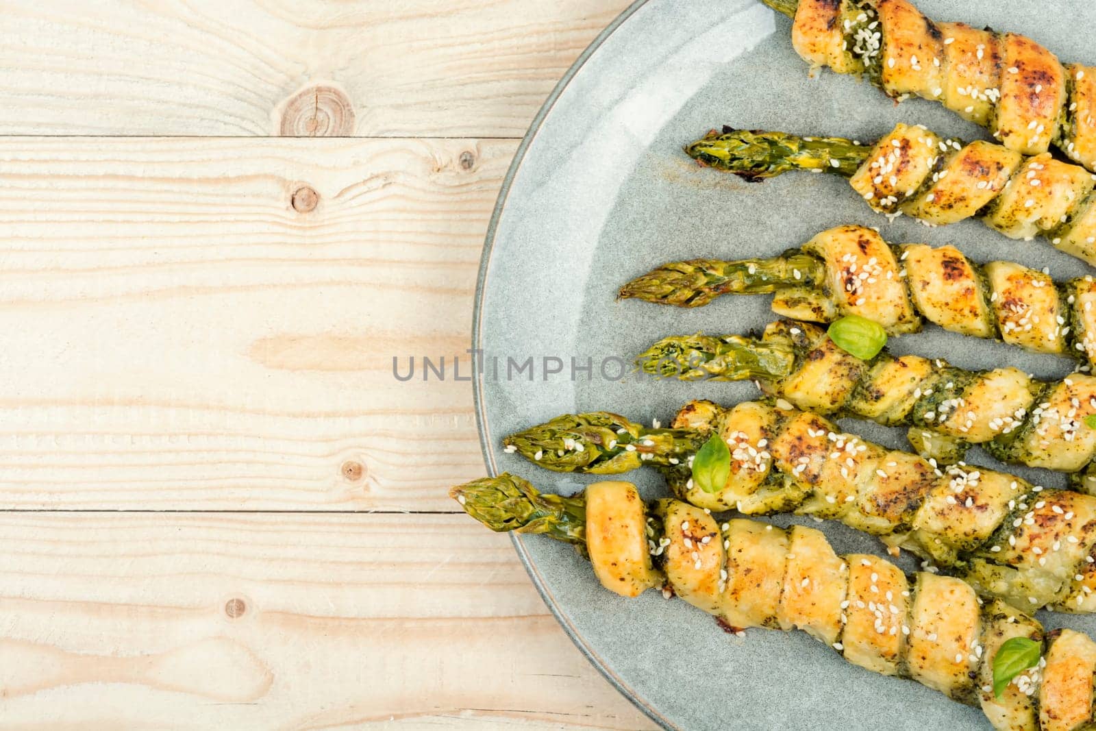 Asparagus baked in puff pastry with pesto sauce. Veggie food.