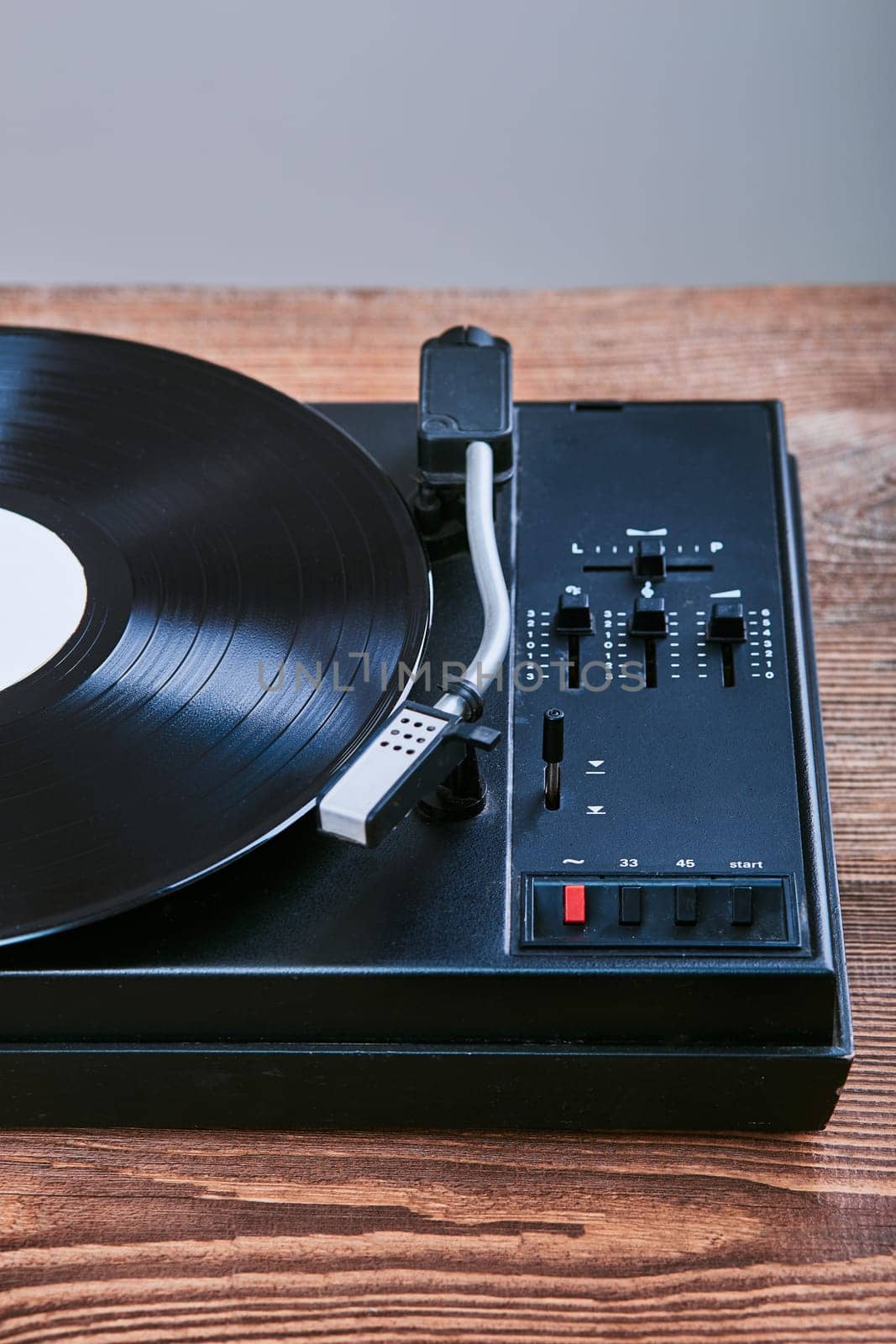 Turntable vinyl player with black vinyl record. Classic stereo set. Candid people, real moments, authentic situations
