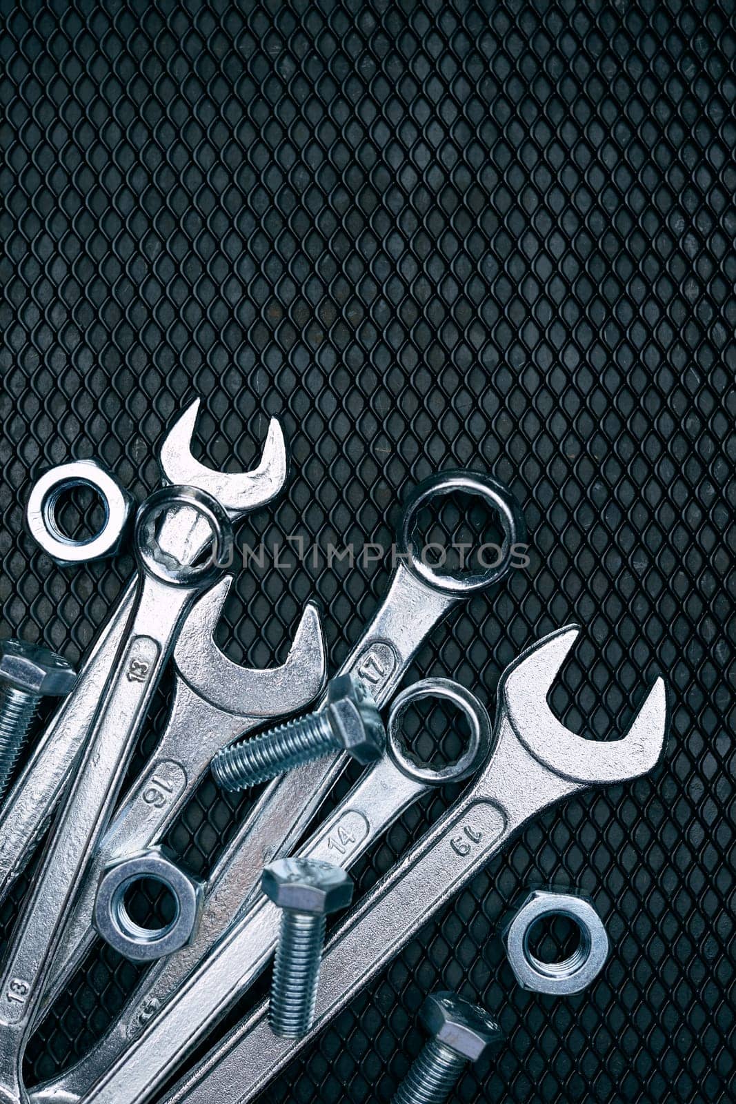 Set of chrome wrenches on steel surface. Mechanic tools for maintenance. Hardware tools to fix. Technical tools background