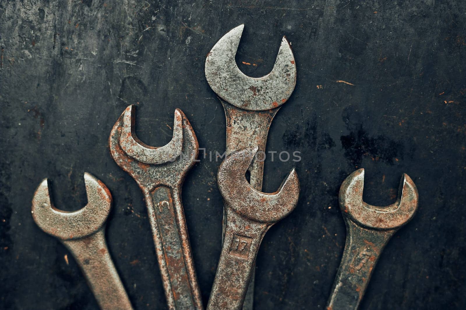 Spanners on steel surface. Old rusty wrenches for maintenance. Mechanic hardware tools to fix. Technical tools background with copy space