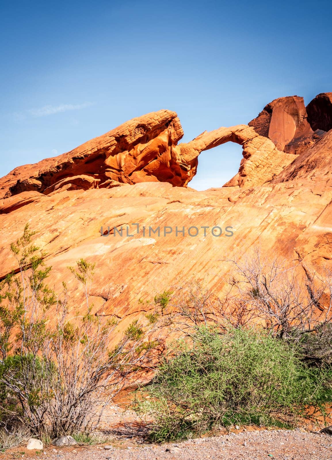 Moon rising over Arch Rock formation in Valley of Fire State Park in Nevada