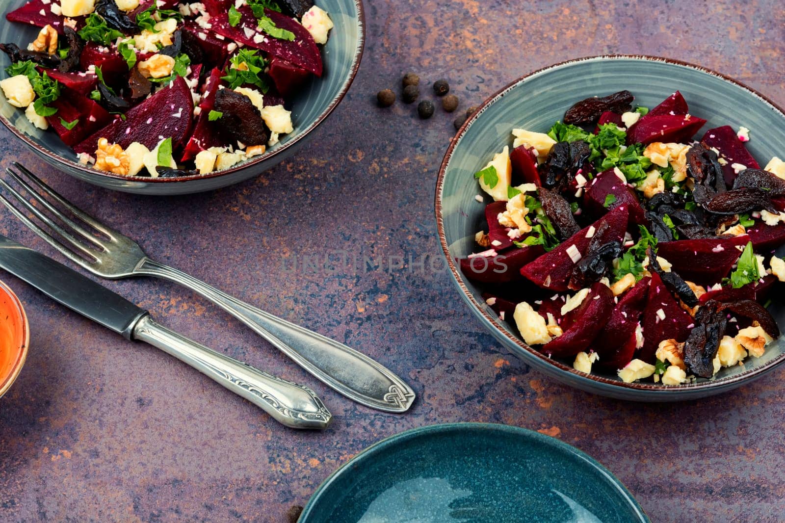 Diet salad of beets, nuts and cheese on the plate.