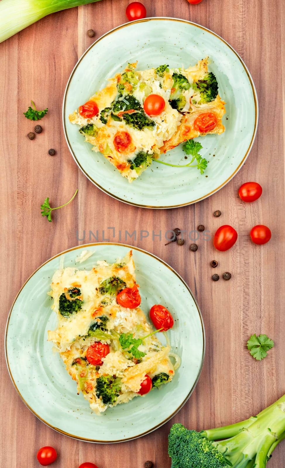 Diet potato casserole with broccoli and tomatoes on a plate. copy space,space for text