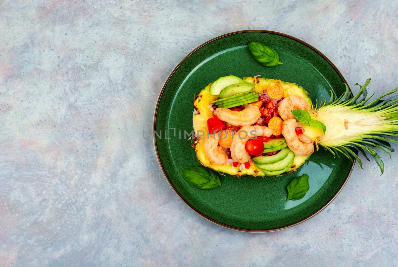 Delicious pineapple stuffed with vegetables, rice, avocado and shrimps. Peruvian food