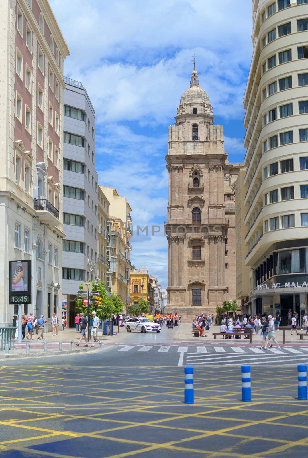 Malaga, Spain, April 2023: View on Molina Lario street with Cathedral of Malaga in the background