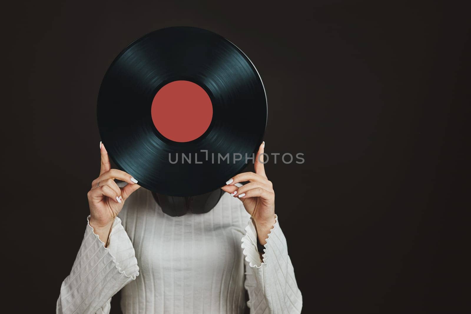 Woman holding vinyl record. Music passion. Listening to music from analog record. Playing music from analog disk on turntable player. Enjoying music from old collection. Retro and vintage. Stereo audio. Analog sound