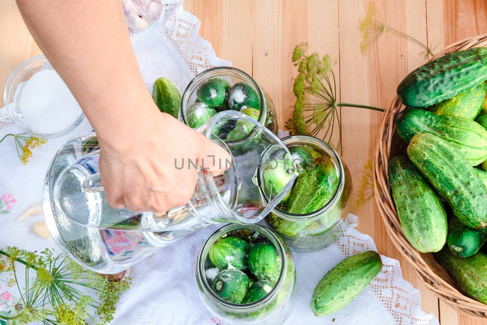 Pickling the cucumbers with home garden vegetables and herbs, fresh vegetables picked straight from field, collected on wooden table outdoors. View from above