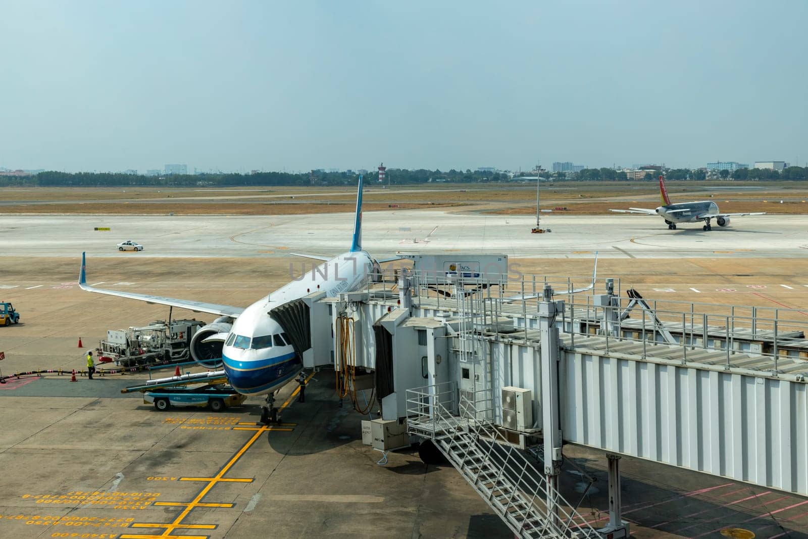 Ho Chi Minh / Vietnam - March 30, 2019: China Southern Airlines flight is loading in Ho Chi Minh Airport for its next flight and another far away flight is preparing to fly