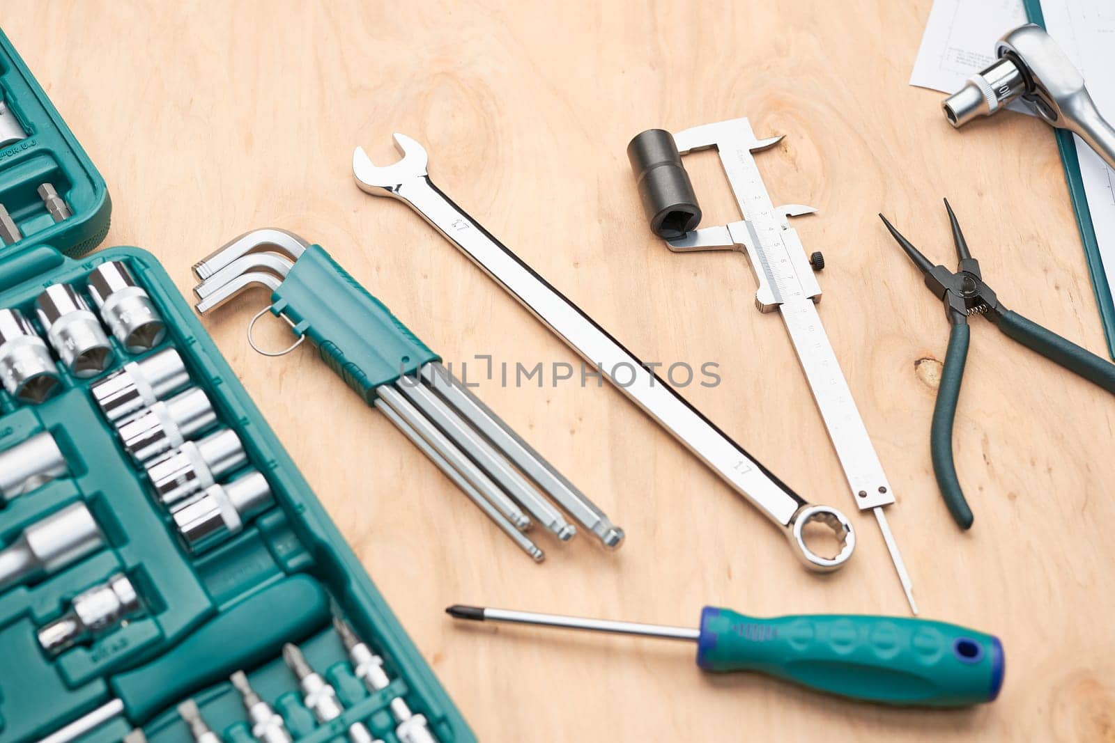 Workshop table with many tools. Wrench, spanner, calliper and ratchet with many attachments. Work tools. Universal tool set. Professional equipment. Background