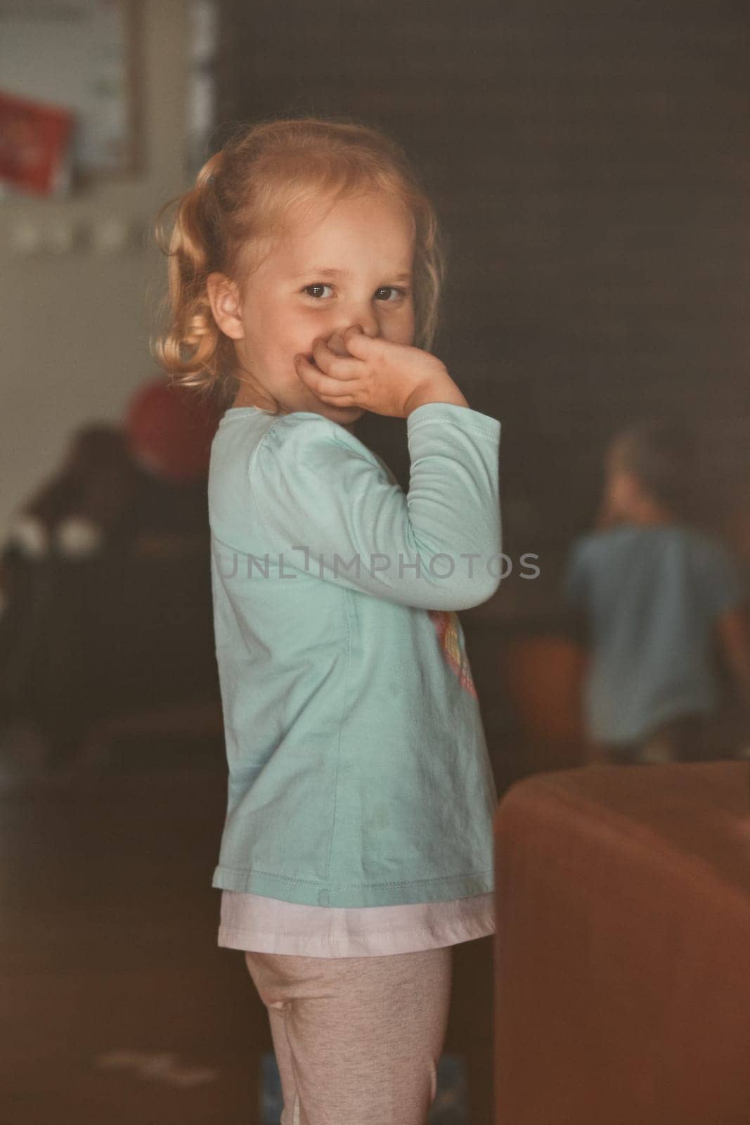 Little adorable girl posing for a portrait. Real people, authentic situations