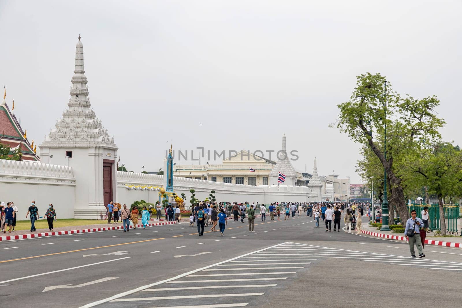 Bangkok,Thailand - April 16, 2023: Na Phra Lan Road is the road in front of Wat Phra Kaew. or the Grand Palace of Thailand Closed to traffic for a large number of tourists to walk around the place.